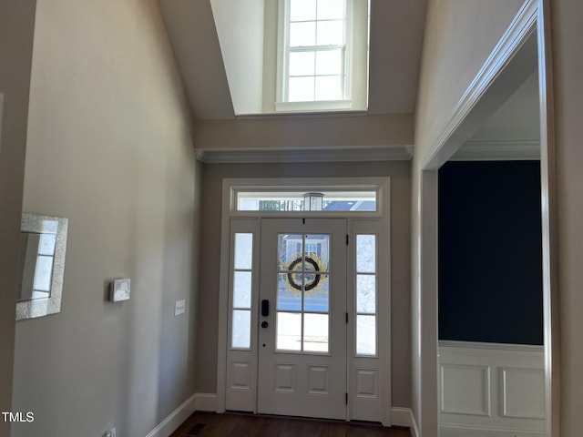 foyer with dark wood-style flooring and baseboards