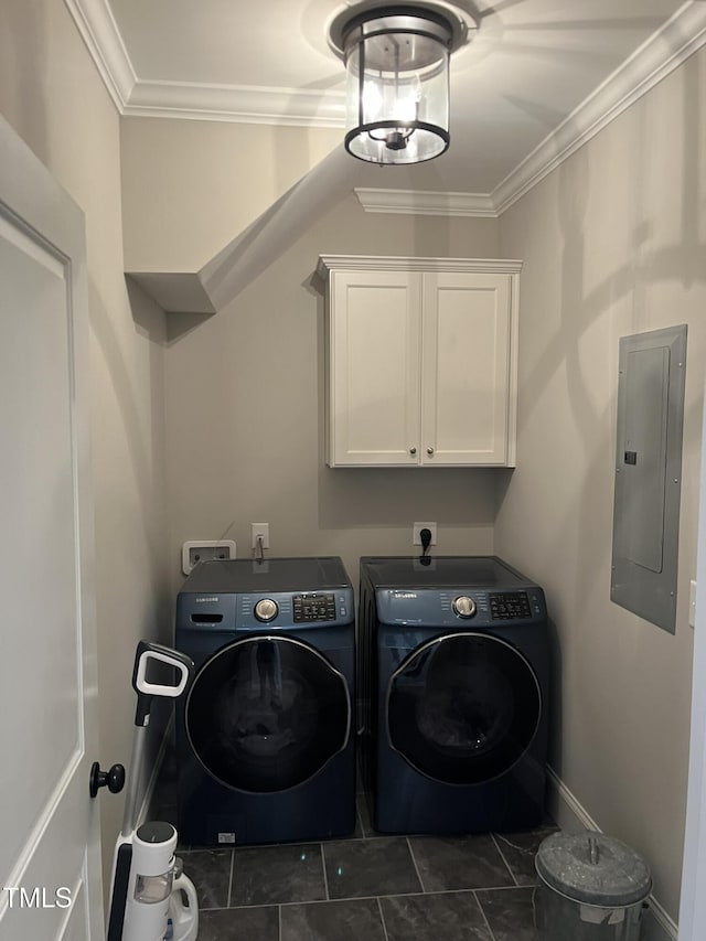 laundry room with crown molding, electric panel, cabinet space, and washing machine and clothes dryer