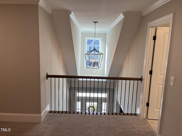 interior space featuring ornamental molding, carpet, baseboards, and an inviting chandelier