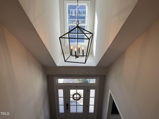 foyer entrance with a healthy amount of sunlight and a notable chandelier