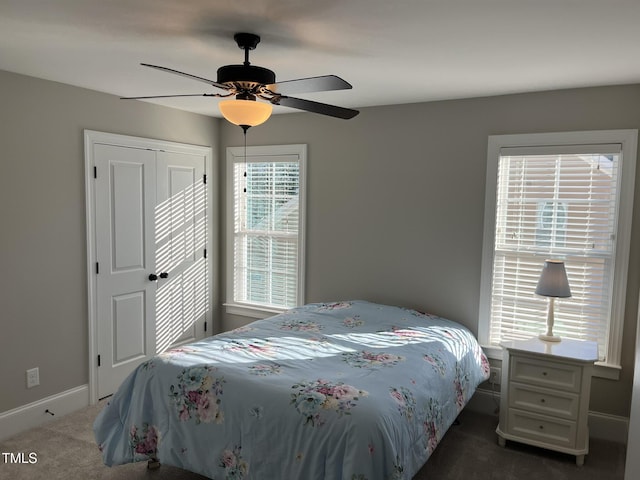 bedroom with ceiling fan, carpet floors, a closet, and baseboards