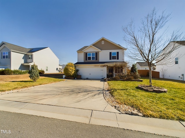 traditional home featuring a garage, a front yard, concrete driveway, and fence