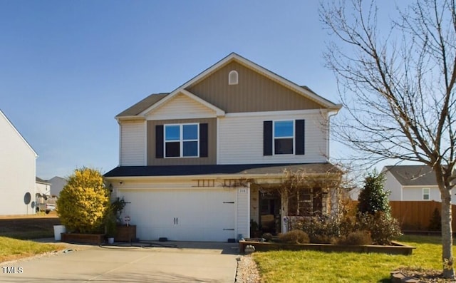 traditional-style home featuring driveway, a garage, and a front lawn