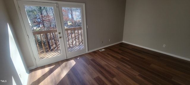 interior space featuring dark wood-type flooring, visible vents, and baseboards