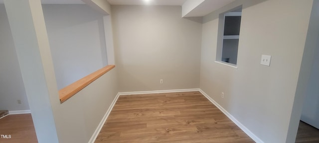 interior space featuring wood finished floors and baseboards