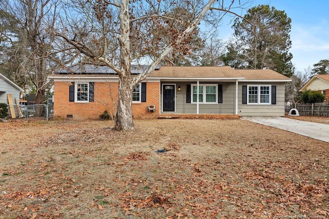 ranch-style home with crawl space, fence, concrete driveway, and brick siding