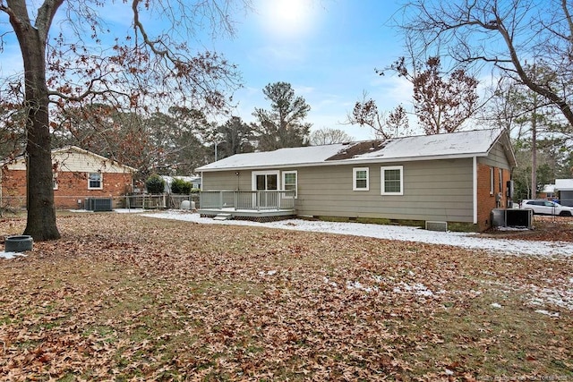 rear view of house featuring central air condition unit, fence, and a deck