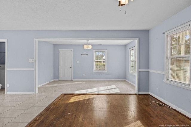 interior space with light wood finished floors, visible vents, baseboards, and ceiling fan