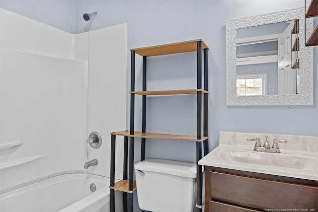 full bath featuring toilet, vanity, and washtub / shower combination