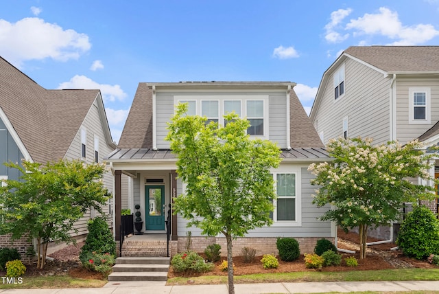 5520 Advancing Ave, Raleigh, NC 27616 - view of front of home with a standing seam roof, a shingled roof, and metal roof