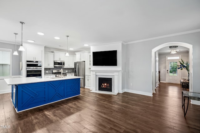 5520 Advancing Ave, Raleigh, NC 27616 - kitchen featuring stainless steel appliances, a sink, ornamental molding, dark wood finished floors, and baseboards
