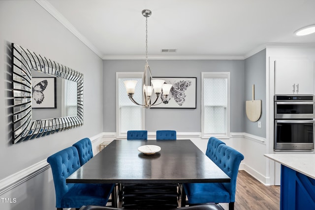 5520 Advancing Ave, Raleigh, NC 27616 - dining space with a chandelier, ornamental molding, and wood finished floors