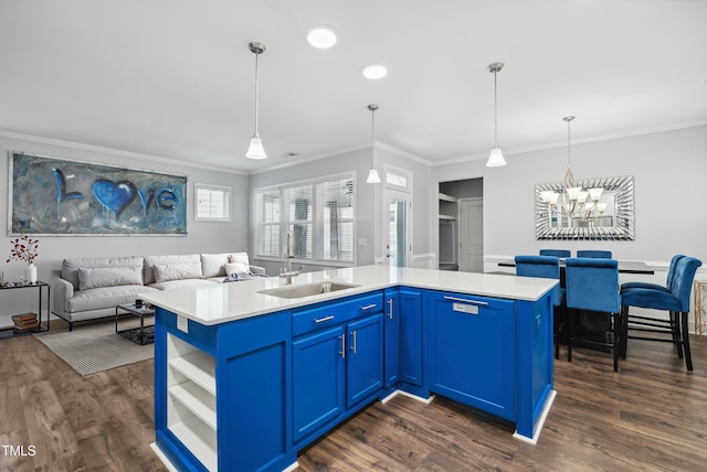 5520 Advancing Ave, Raleigh, NC 27616 - kitchen featuring a sink, blue cabinets, ornamental molding, a chandelier, and dark wood-type flooring