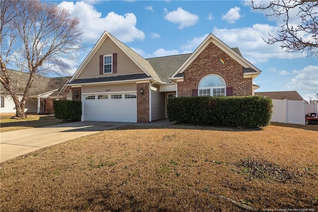 view of front of property featuring an attached garage, brick siding, a shingled roof, fence, and driveway