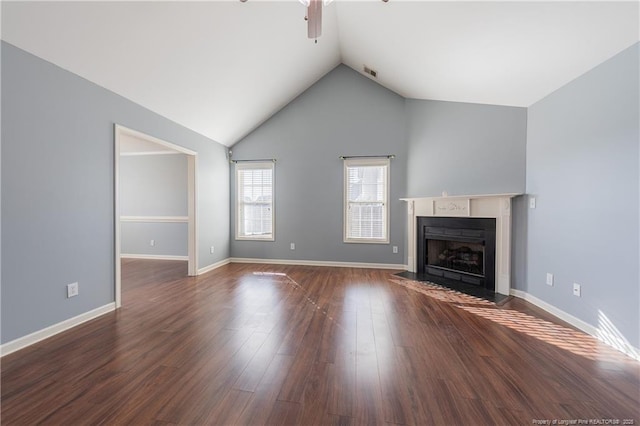 unfurnished living room featuring dark wood-style floors, a fireplace, baseboards, and vaulted ceiling