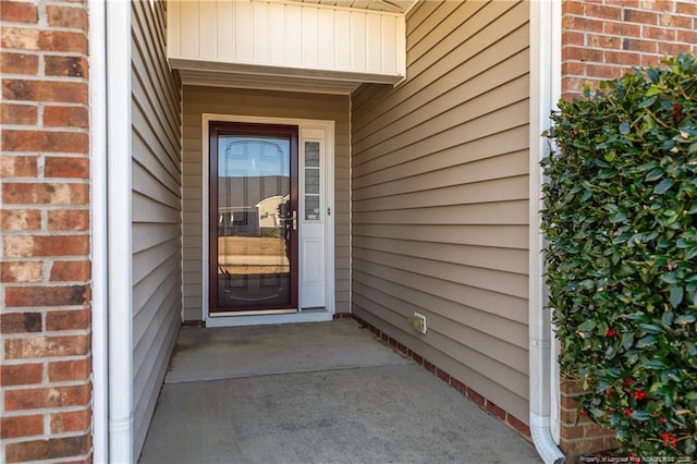 entrance to property with brick siding