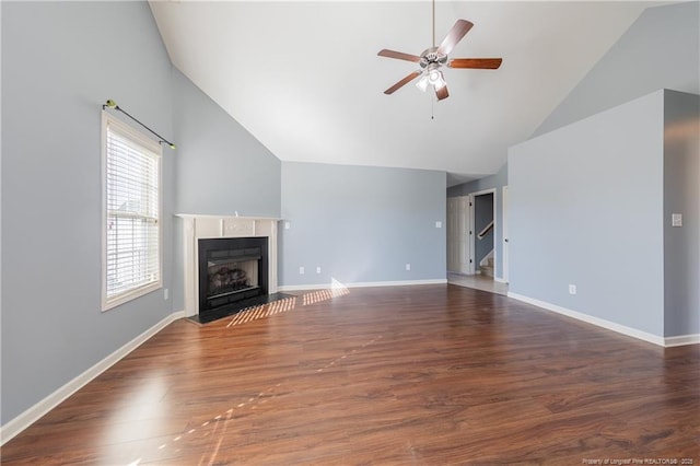 unfurnished living room featuring ceiling fan, high vaulted ceiling, a fireplace with flush hearth, baseboards, and dark wood finished floors