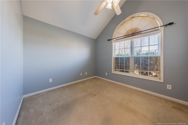 spare room with lofted ceiling, light carpet, baseboards, and a ceiling fan