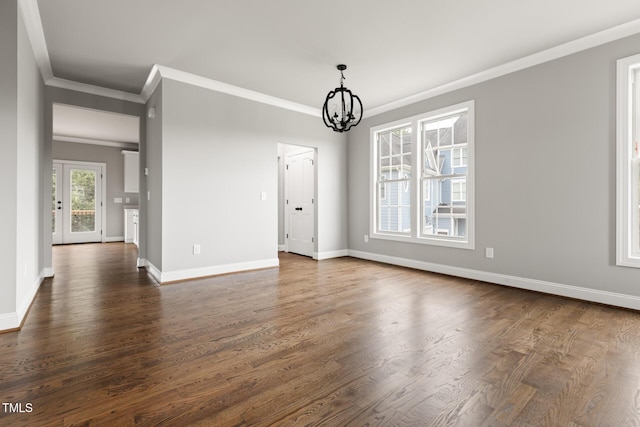 interior space with baseboards, dark wood-type flooring, crown molding, and a notable chandelier