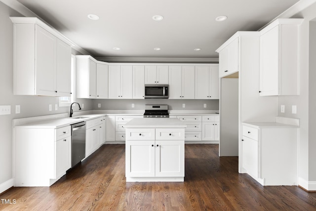 kitchen featuring a sink, stainless steel appliances, light countertops, and white cabinetry