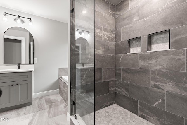 bathroom featuring marble finish floor, vanity, baseboards, and walk in shower