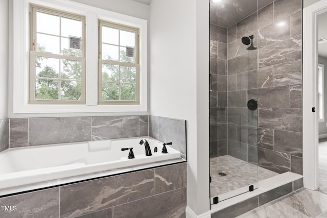 bathroom featuring a garden tub and a shower stall