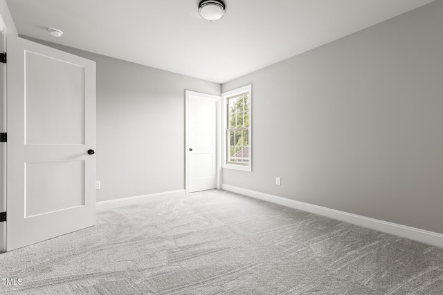 empty room with carpet floors and baseboards