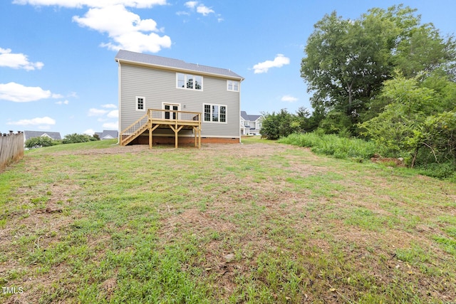 back of house with stairs, a yard, a deck, and fence