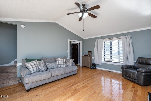 living room with visible vents, a ceiling fan, stairs, vaulted ceiling, and light wood-style floors