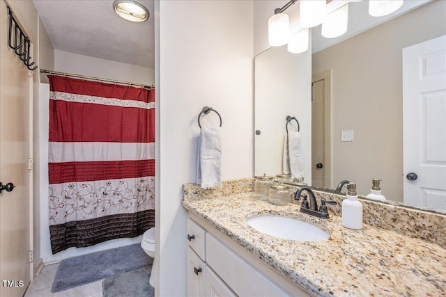 full bathroom with toilet, tile patterned flooring, a textured ceiling, and vanity