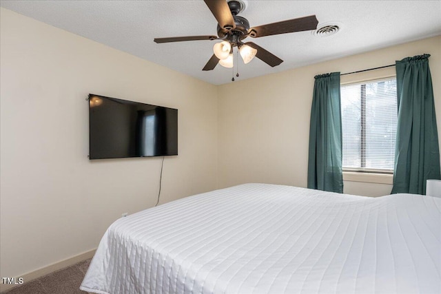 bedroom featuring carpet, visible vents, ceiling fan, a textured ceiling, and baseboards