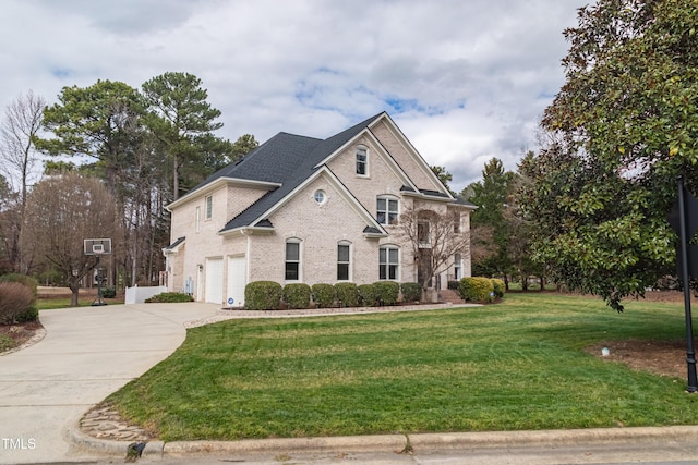 view of front of house with a garage, driveway, a front lawn, and brick siding