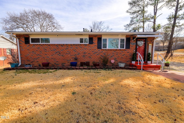 view of front of property with brick siding and a front yard