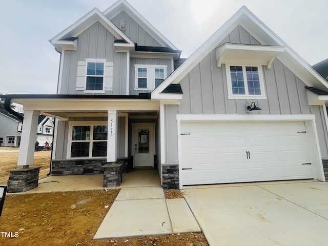 craftsman inspired home featuring covered porch, board and batten siding, and driveway