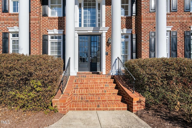 property entrance featuring brick siding