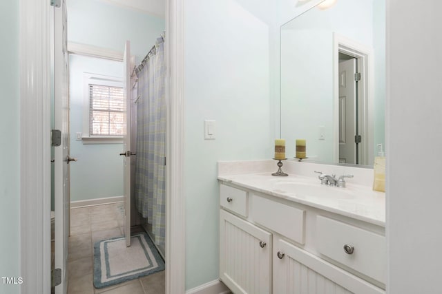 full bath featuring tile patterned flooring, baseboards, and vanity