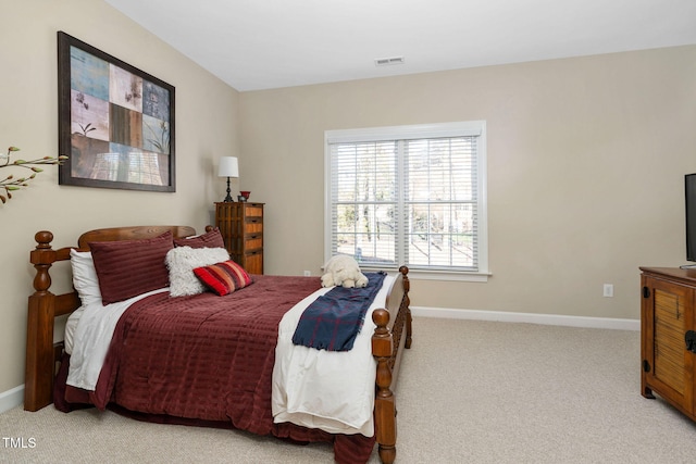 bedroom with light carpet, visible vents, and baseboards