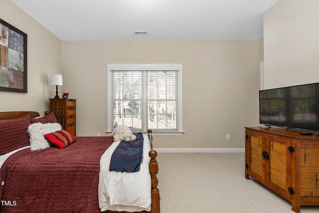 bedroom with light carpet, visible vents, and baseboards