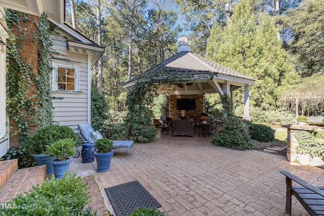 view of patio featuring a gazebo and an outdoor fireplace