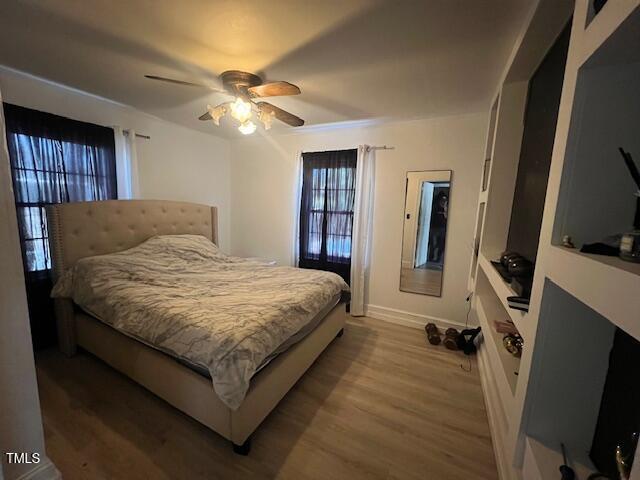 606 N Orange Ave, Dunn, NC 28334 - bedroom featuring a ceiling fan, baseboards, and wood finished floors