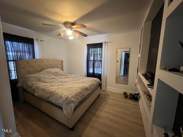 606 N Orange Ave, Dunn, NC 28334 - bedroom with a ceiling fan, baseboards, and wood finished floors