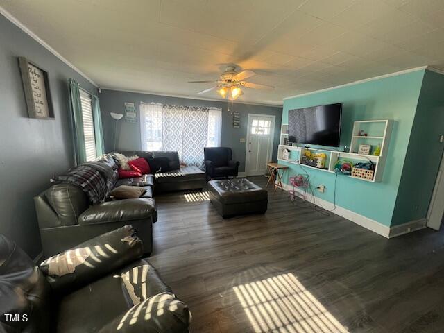 living room featuring ornamental molding, dark wood finished floors, and baseboards