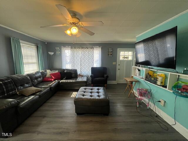 606 N Orange Ave, Dunn, NC 28334 - living room featuring dark wood-style floors, plenty of natural light, a ceiling fan, and crown molding