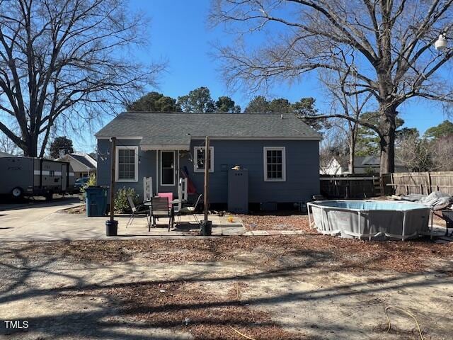 606 N Orange Ave, Dunn, NC 28334 - view of front of property featuring a patio area, fence, and a fenced in pool