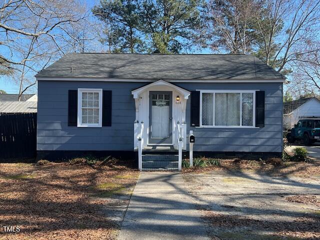 bungalow with entry steps and driveway