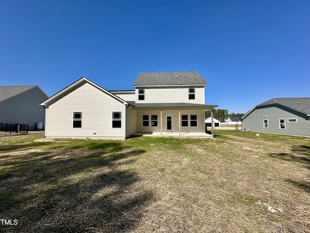 rear view of house featuring a patio and a yard