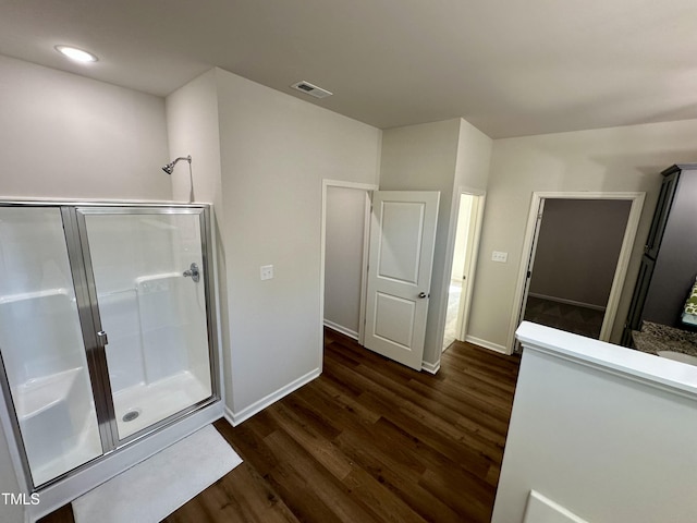 full bath with visible vents, wood finished floors, recessed lighting, a shower stall, and baseboards