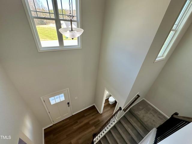 stairway featuring baseboards and wood finished floors