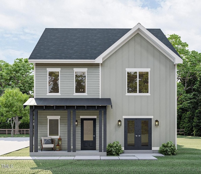 view of front of property with metal roof, board and batten siding, and a front yard