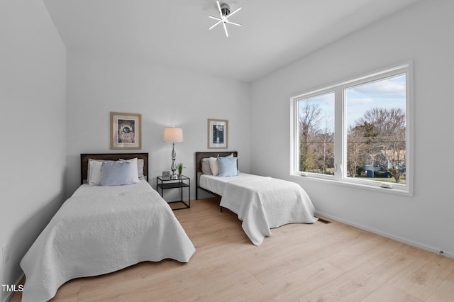 bedroom featuring baseboards and wood finished floors